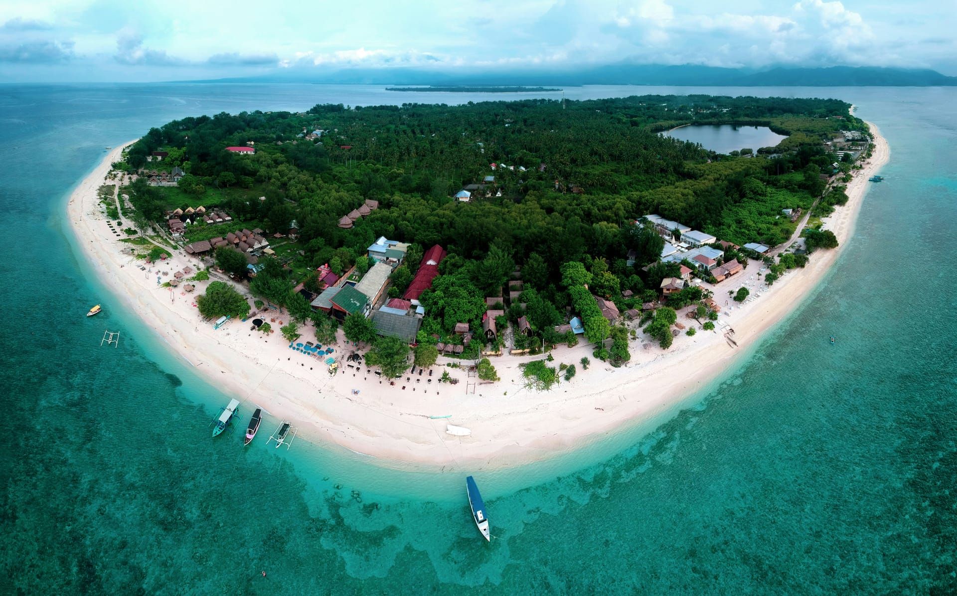 Aerial view of a Gili island ringed by white sand
